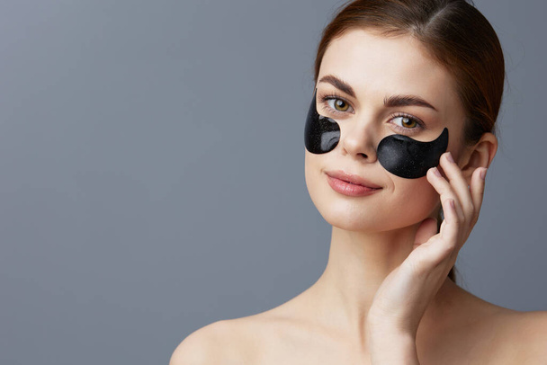 pretty woman with  skin care anti wrinkle eye patches close-up Lifestyle. High quality photo - Foto, imagen