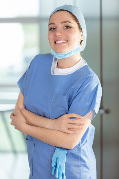 happy female doctor or nurse wearing face mask hair net - Foto, imagen