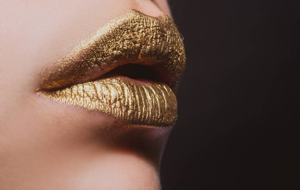 Sexy lips. Closeup sexy beautiful female golden lips isolated. Gold lipstick. - Fotoğraf, Görsel