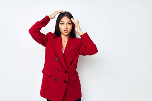 attractive girl in a red jacket cosmetics smile studio model unaltered - Valokuva, kuva