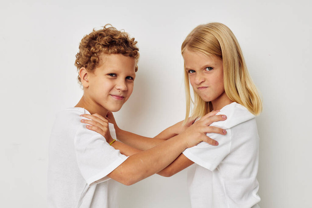 Little boy and girl in white T-shirts are standing next to Lifestyle unaltered - Foto, immagini
