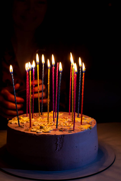 birthday cake with burning candles for birthday, holiday party - 写真・画像