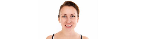 young woman with a smile with snow-white teeth looking at the camera on a white background - Foto, Bild