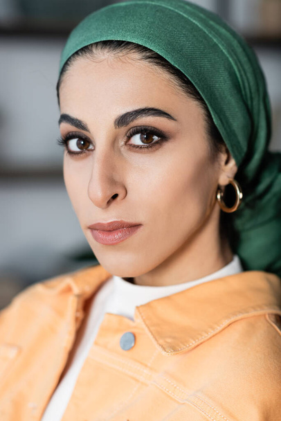 close up portrait of young muslim woman in headkerchief and golden earring - Photo, Image