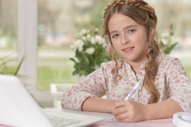 beautiful young girl with laptop studying - Fotó, kép