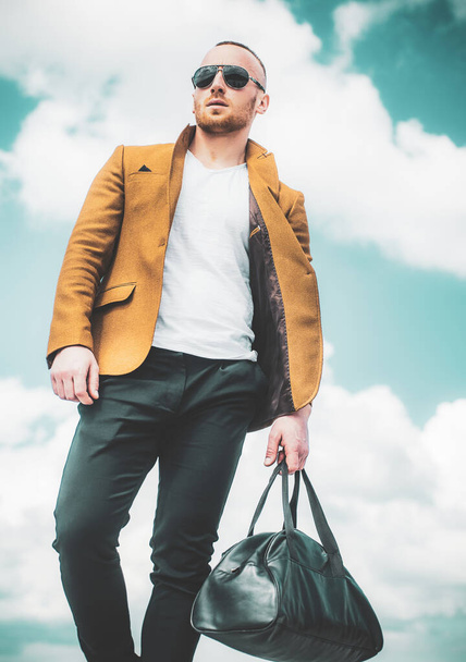 Portrait of young stylish man with bag in the street, life style. - Foto, immagini