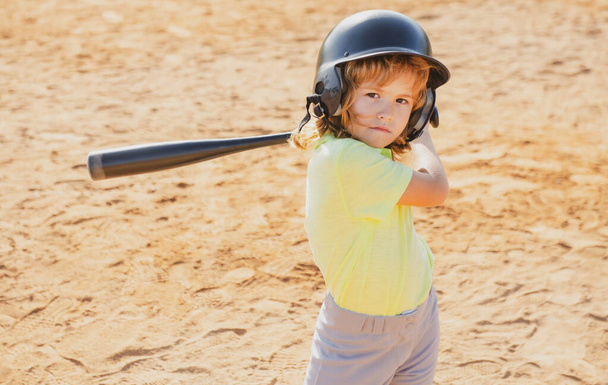 Boy in baseball helmet and baseball bat ready to bat. - Foto, Imagen