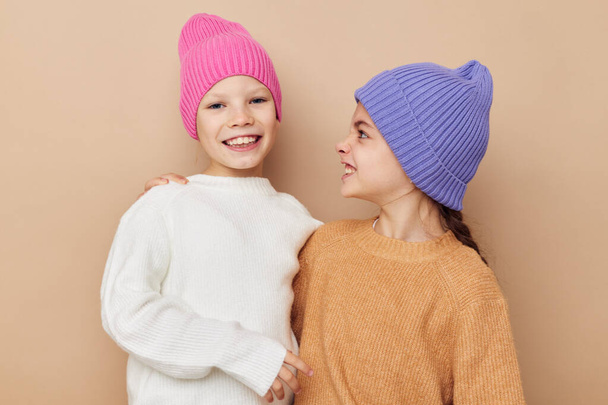 two funny girls hugging posing colorful hats - Photo, Image