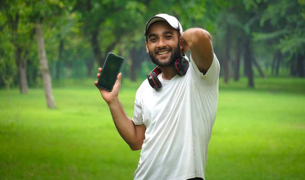 man with mobile phone and headphone happy - Фото, зображення