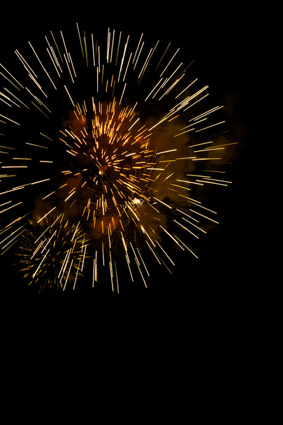 A burst of golden fireworks against a night sky. - Photo, Image