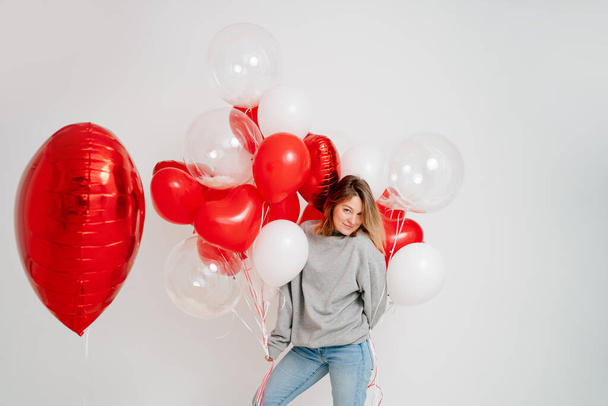 an blonde woman with balloons on a white background.  - Fotografie, Obrázek
