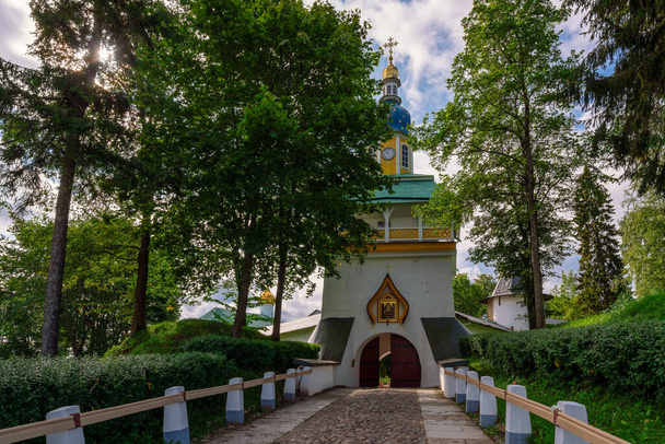 View of the main entrance of the Holy Dormition Pskov-Pechersk Monastery Petrovskaya Tower with entrance gates on a sunny summer day, Pechory, Pskov region, Russia - Photo, Image