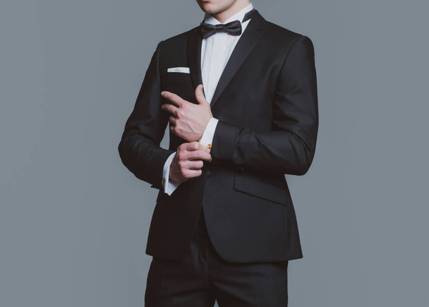 Formal classic suit. Business style outfit. Retro suit fashion. Handsome businessman adjusting his sleeves. - Fotó, kép