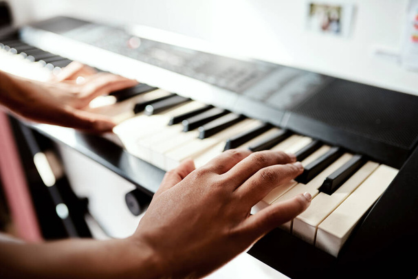 I may not have the words but my piano will. Cropped shot of a woman playing music on a keyboard at home. - Foto, immagini