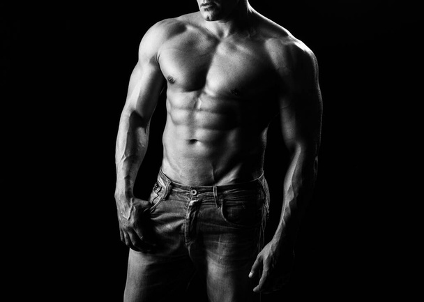 Sexy guy man on black. Handsome fitness young bodybuilder with naked torso. Bare abs guy. Sexual muscular male. Homosexual pride, lgbtq lgbt. - 写真・画像