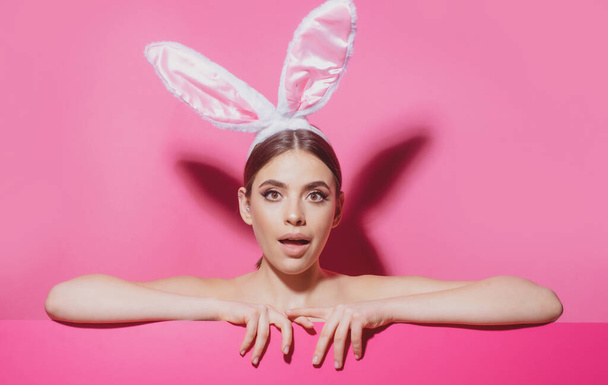 Close-up portrait of attractive lovely pretty cheerful girl wearing pink ears. Easter woman with rabbit ears. - Foto, immagini
