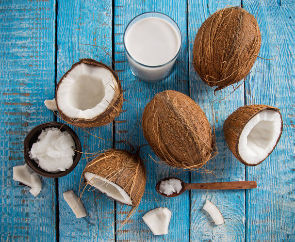 Coconut pieces on wooden background - Fotó, kép
