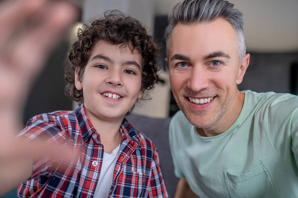 Close-up of dad with son smiling at camera - Photo, image