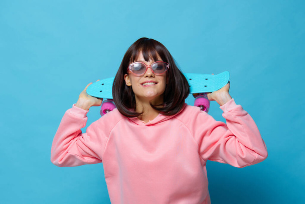 beautiful woman blue skateboard posing fun isolated background - Фото, изображение