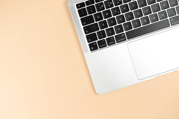 Modern laptop keyboard flat lay beige background. Office workplace table, minimal design concept. Top view, copy space - Fotografie, Obrázek
