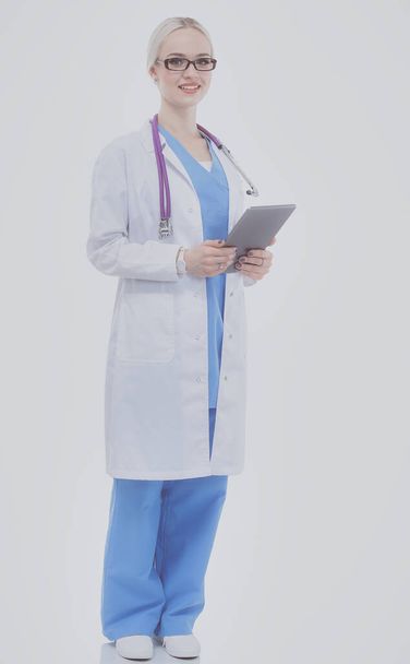 Female doctor using a digital tablet and standing on white background. Woman doctors. - Fotó, kép