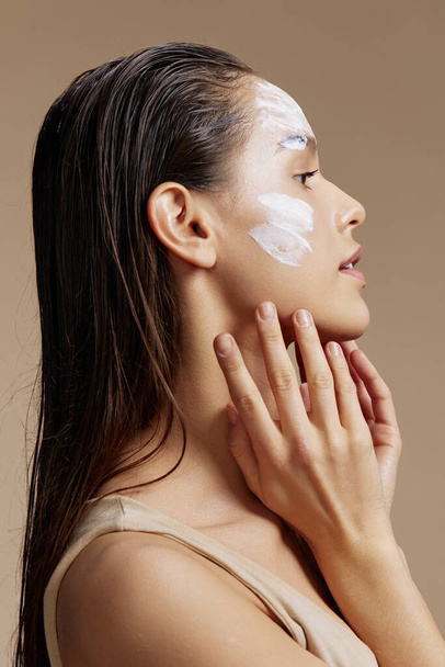 woman face mask cream clean skin facial scrub beige background - Fotó, kép