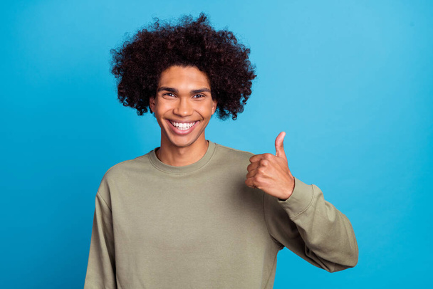 Photo of young man show thumb-up feedback good suggest advertise isolated over blue color background - Фото, зображення