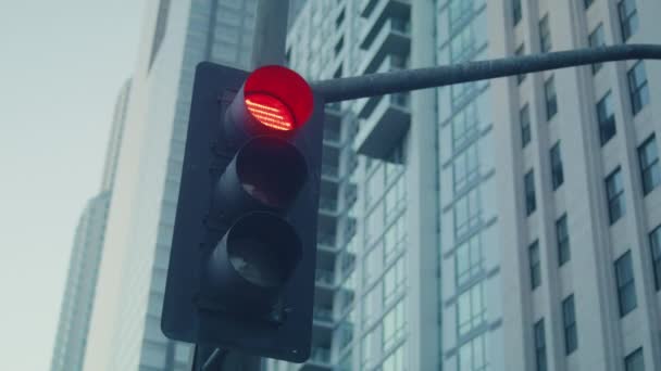 Traffic light change color on crossroad big city. Streetlight on road closeup - Footage, Video