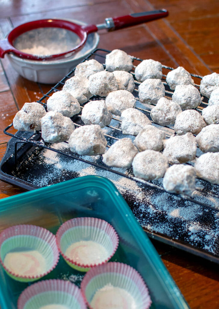 A favorite cookie, called a snowball, mexican wedding cookie, russian wedding cookie or pecan sandies, are dusted with a layer of powdered sugar. - Photo, Image