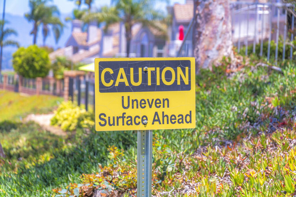 Yellow caution signage on a metal post in Laguna Niguel in California - Photo, Image