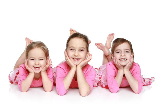 μικρή, ευτυχής κορίτσια που κείνται σε λευκό φόντο - Φωτογραφία, εικόνα