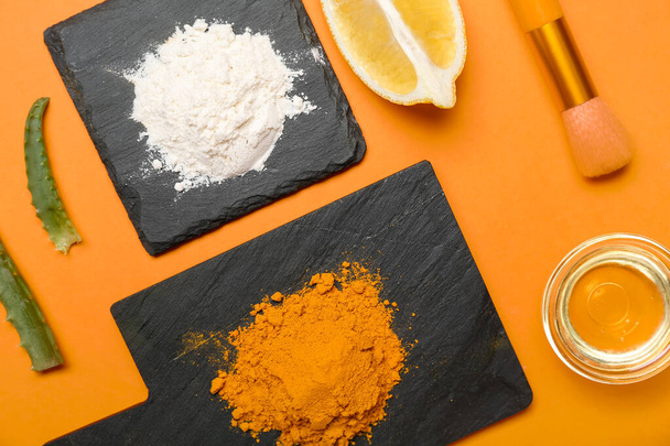 Composition with turmeric mask, powder and oil on orange background - Foto, Imagem