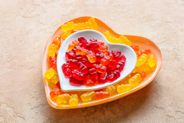 Plate with sweet jelly bears on light background - Photo, Image