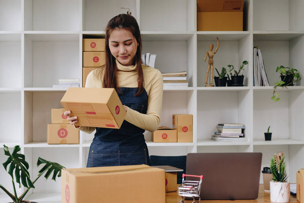 Young asian woman check order for shipping at home, business owner woman start up for business online, SME, Delivery project, woman with Online business or SME concept - Photo, image