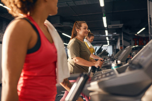 Group of women running on treadmill in gym - Photo, image