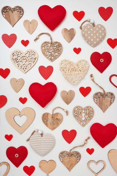 Flat lay Valentine's Day composition made of different hearts on white background - Foto, imagen
