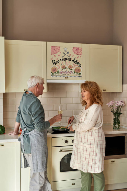 Senior caucasian couple cooking at home kitchen - 写真・画像