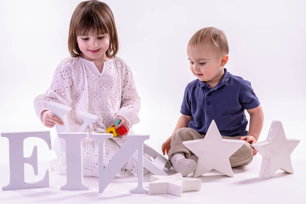 děti hrající si s hračkami na bílém pozadí - Fotografie, Obrázek