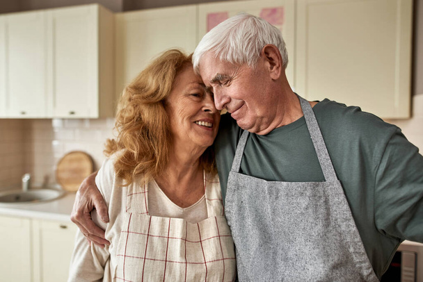 Partial image of man hug his wife at home kitchen - Foto, Imagen