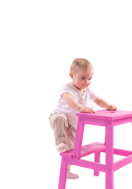 cute little baby boy sitting on the floor, isolated on white background - Фото, зображення