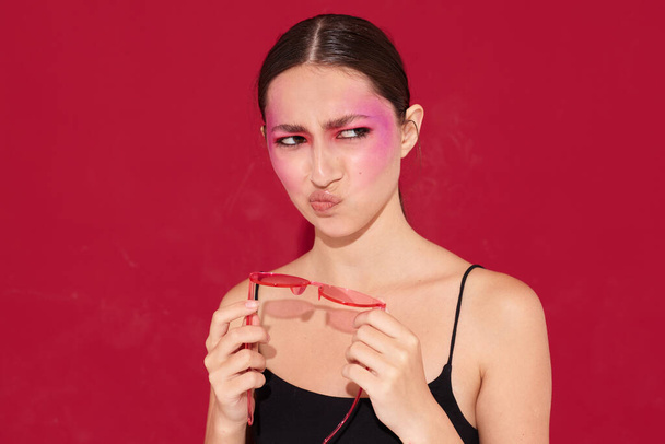 Young beautiful woman in pink glasses makeup emotions cosmetics isolated background unaltered - Φωτογραφία, εικόνα
