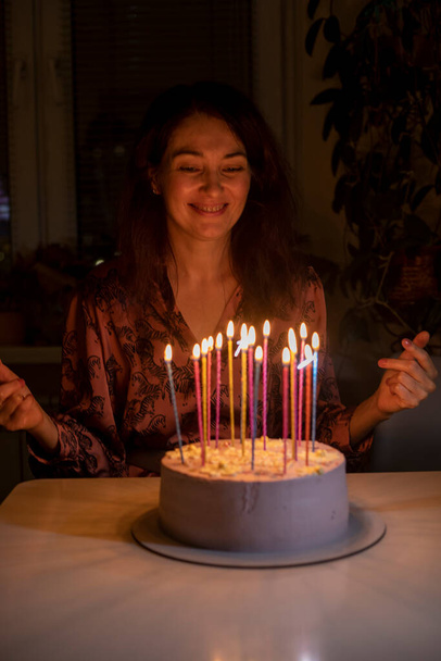 onnellinen tyttö tekee toiveita ennen kuin puhaltaa ulos kakku kynttilöitä hänen syntymäpäivä - Valokuva, kuva