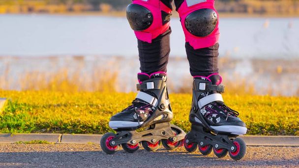 Teenage girl is skating on roller blades in the park. Copy Space - Photo, Image