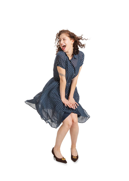 Portrait of young beautiful excited girl in retro style dress, fashion of 70s, 80s years dancing isolated on white studio background with copyspace for ad. - Zdjęcie, obraz