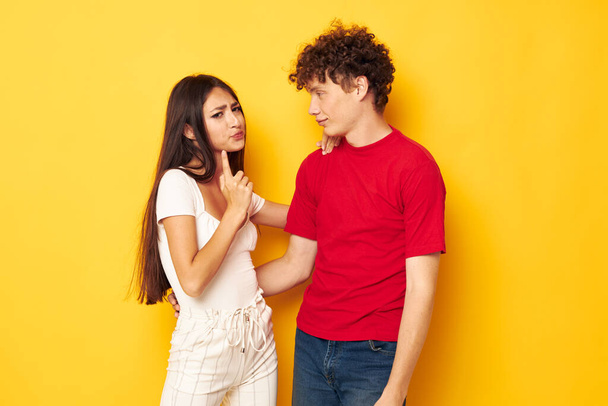 portrait of a man and a woman together posing emotions close-up yellow background unaltered - Photo, Image