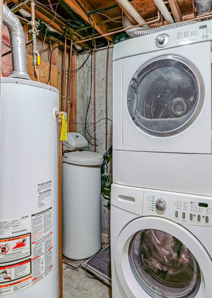 Vertical Sótano interior con electrodomésticos de lavandería y tanque de agua - Foto, imagen