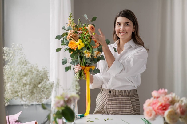 happy woman with bunch of flowers at home - Φωτογραφία, εικόνα