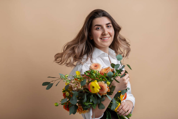 portrait of happy woman holding bunch of flowers - 写真・画像