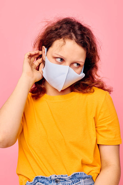cheerful woman medical face mask grimace emotions close-up pink background unaltered - Фото, зображення