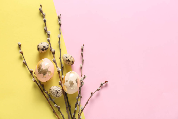 Beautiful Easter eggs and pussy willow branches on color background - Фото, изображение